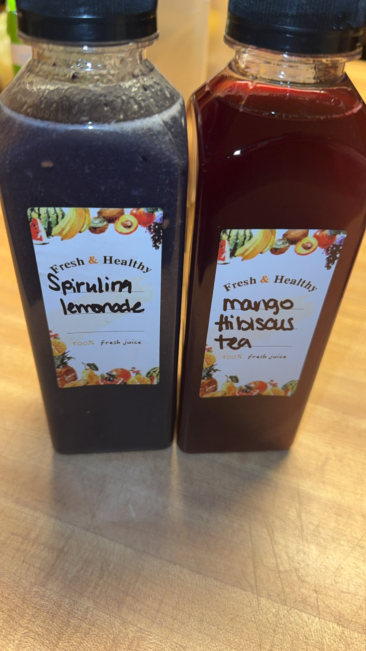 Spirulina lemonade and mango hibiscus tea bottles